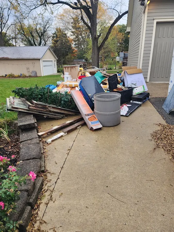 Dumpster being loaded with debris for 12 Yard Dumpster Rental in Rolling Meadows